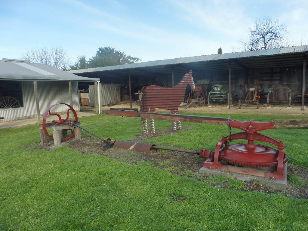 Horse Works shows a long bar to attach to the horse and set of cogs mounted on the ground 